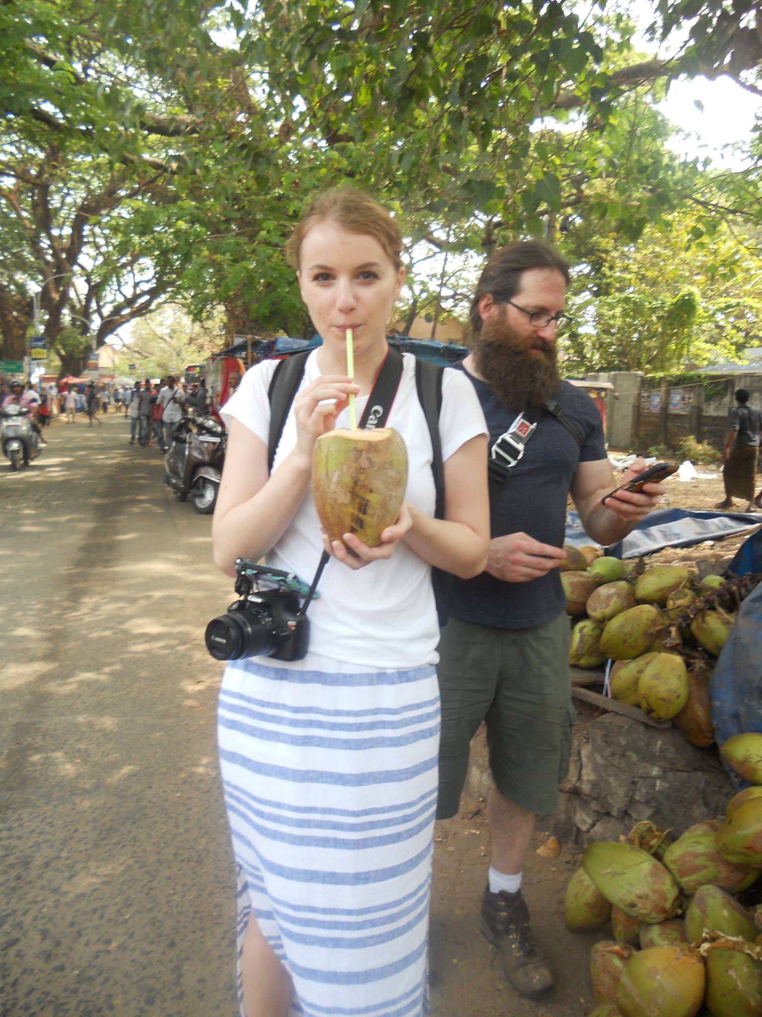 Emily on a trip to India trying a coconut.