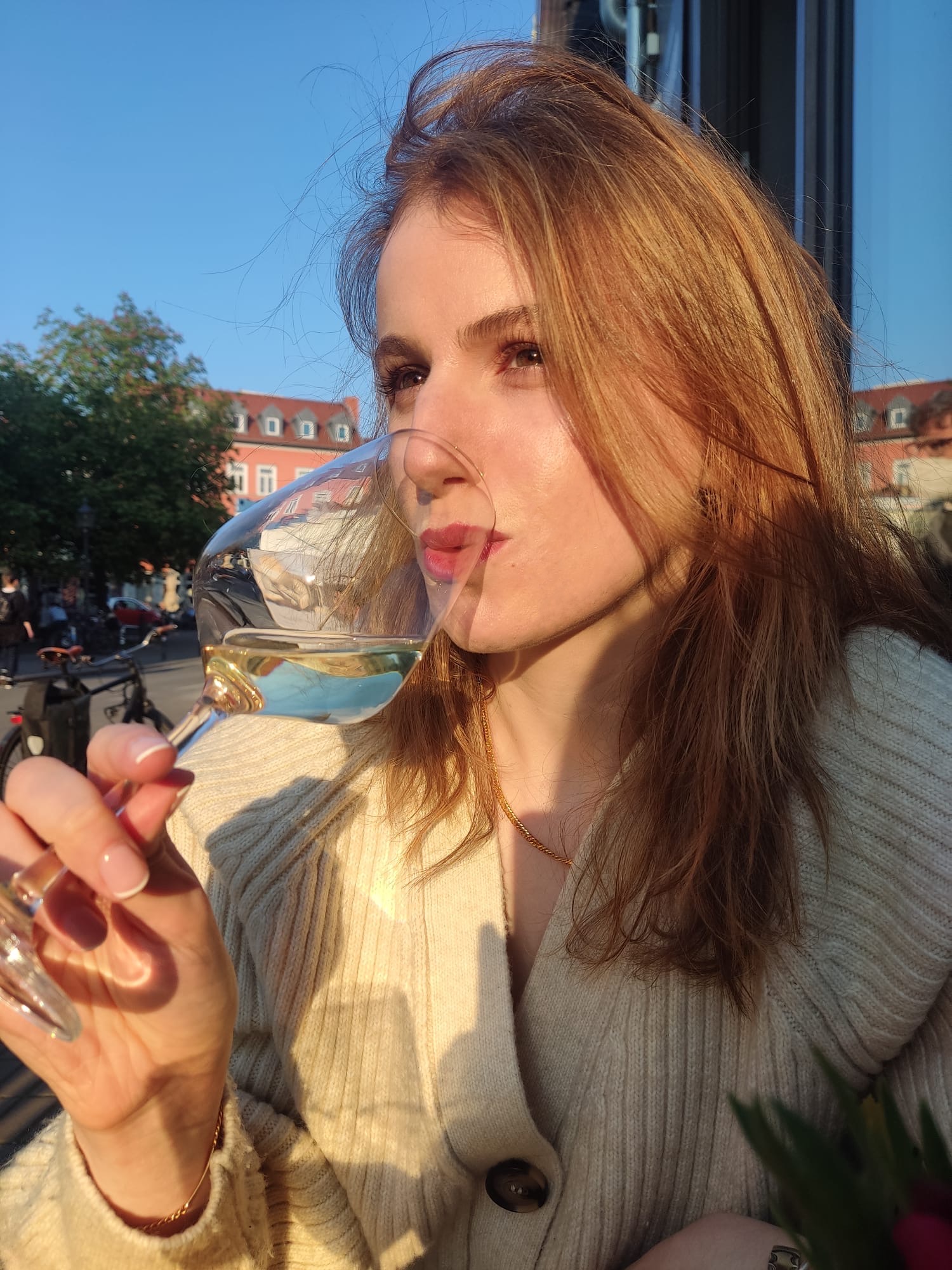Emily sipping wine in Germany.